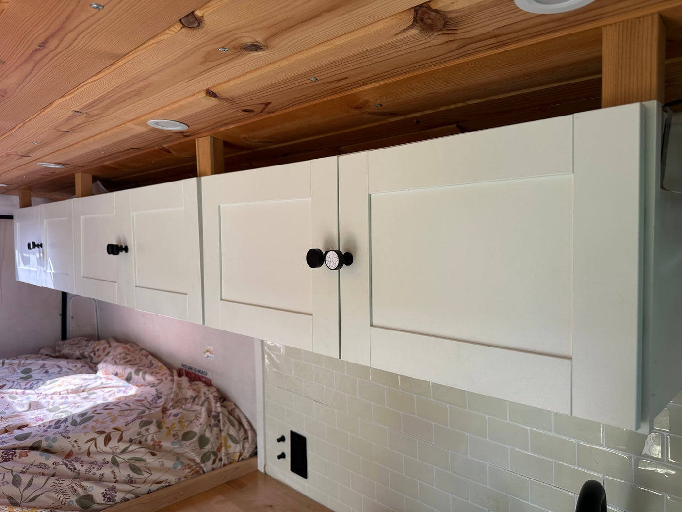 perfect for dining or a mobile office space.|Cozy RV rental interior featuring light overhead cabinets