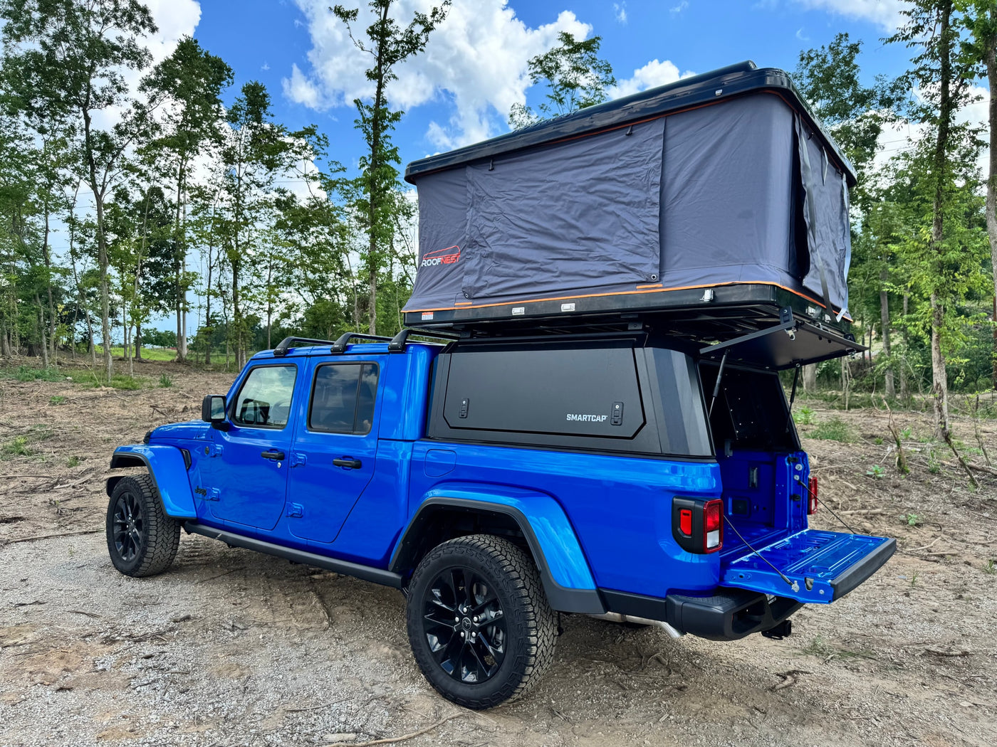 perfect for your next camping RV rental adventure.|Blue Jeep Gladiator with open rooftop tent & bed cap. Ready for adventure — photo 6