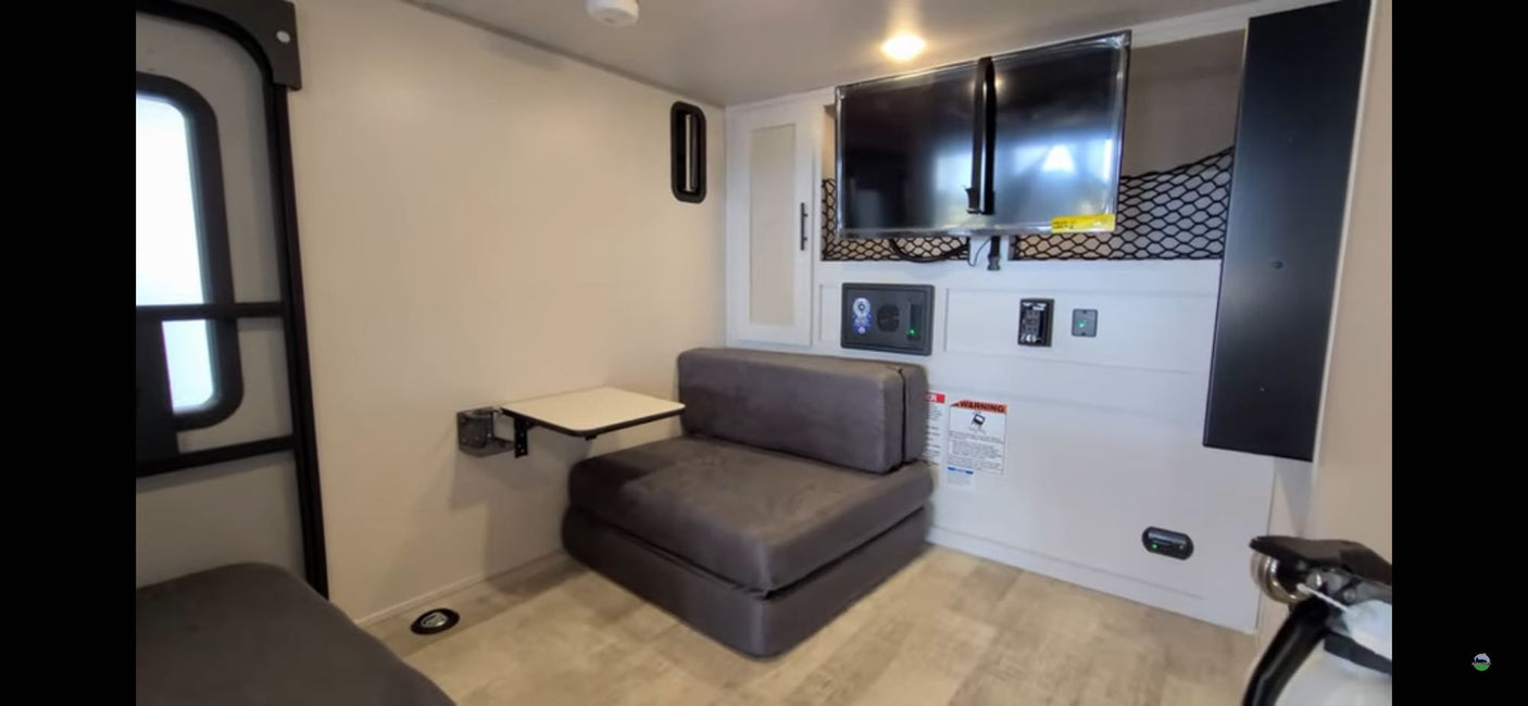 & awning in a colorful yard.|This RV rental camper