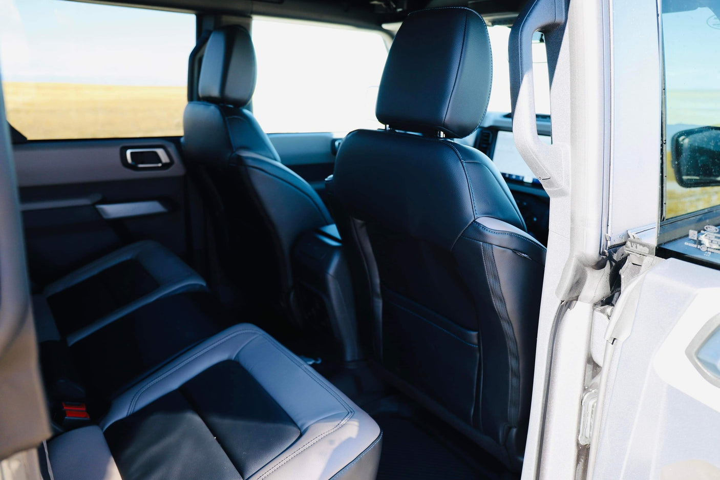 Back seats of a rugged SUV, ideal for your RV rental road trip. Enjoy the view through large windows.