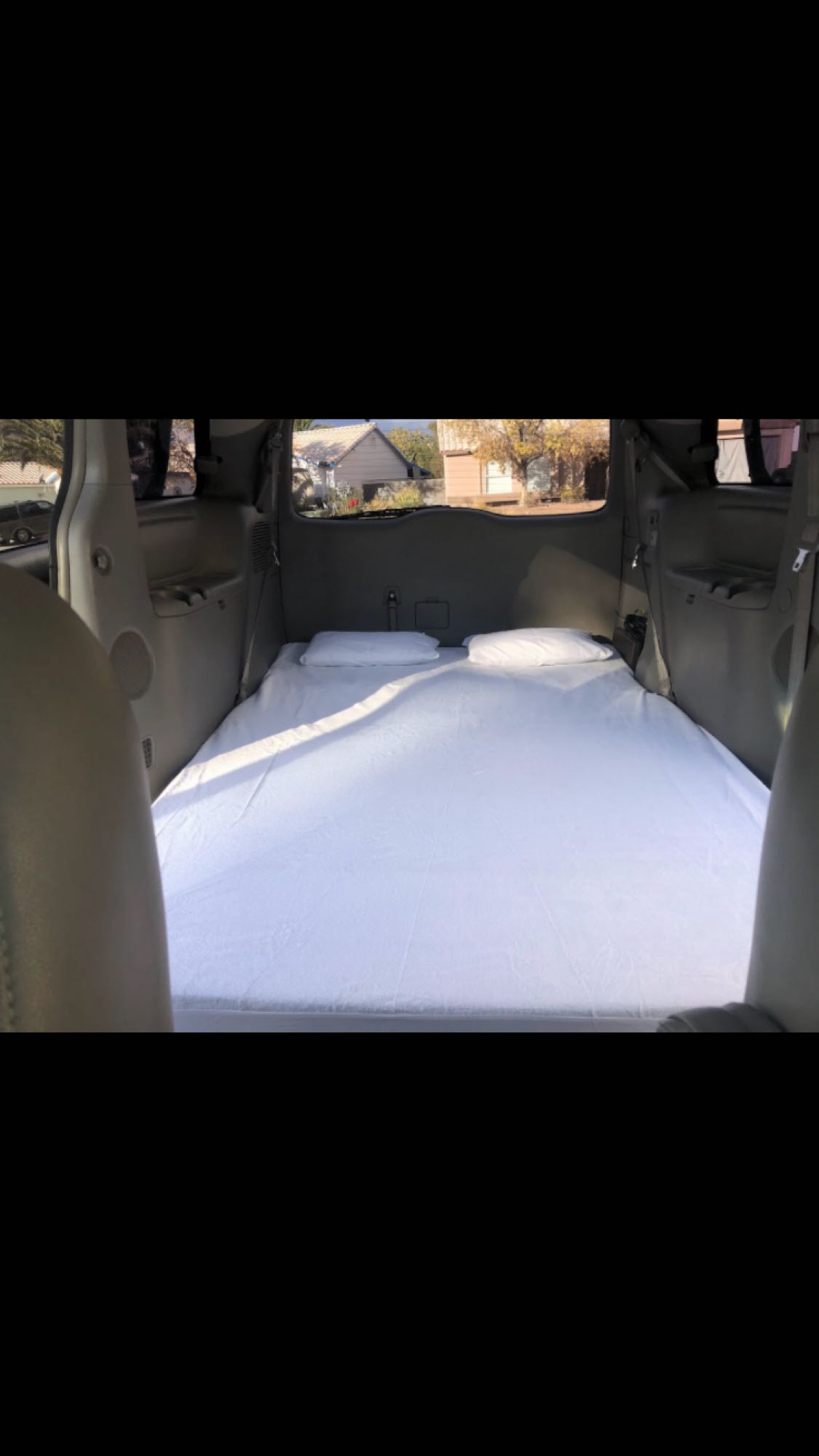 a practical setup for an rv rental or camper conversion.|Spacious RV rental interior with a large gray travel case on the floor between seats — photo 10
