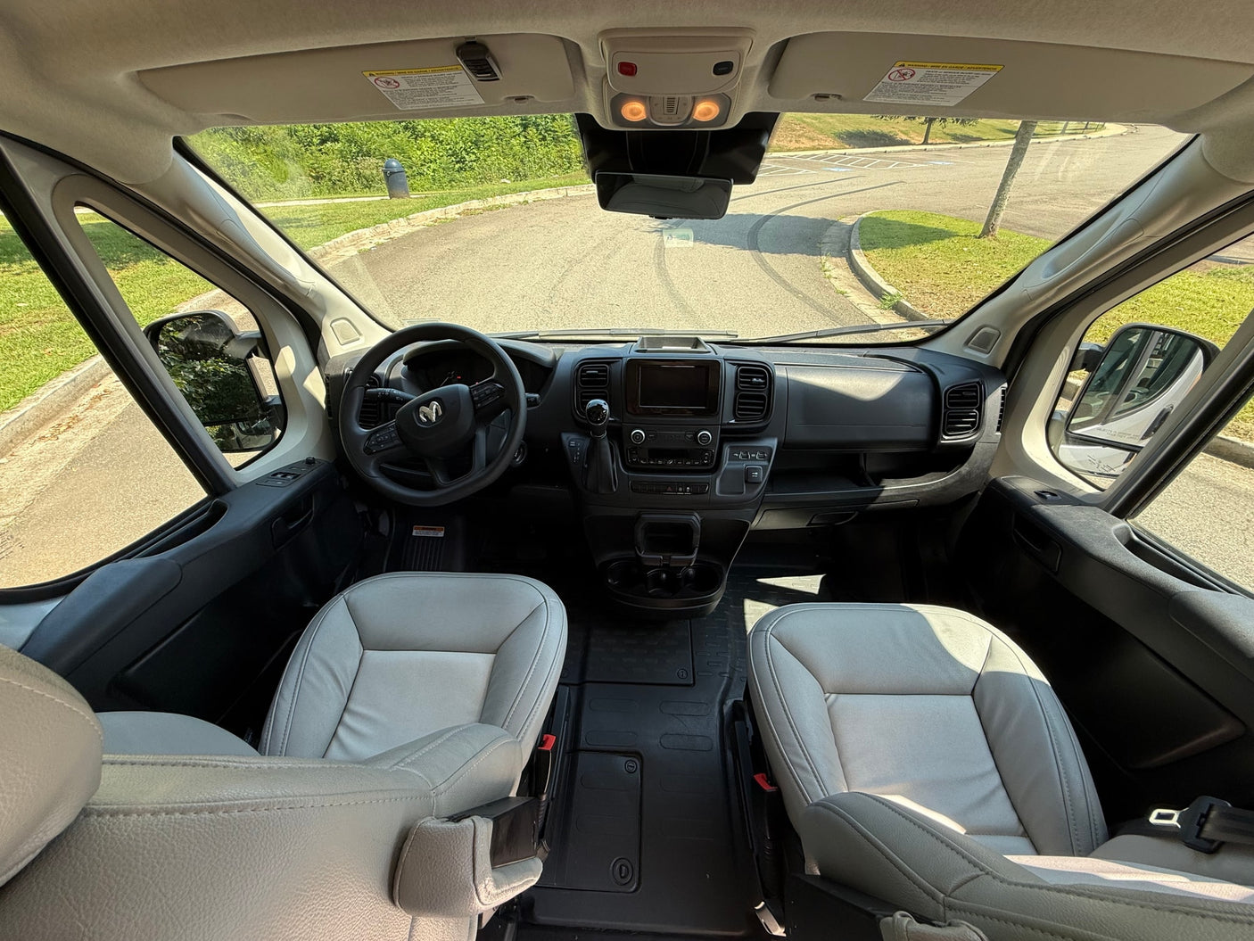 surrounded by trees.|Inside a modern RV rental: view of the bed