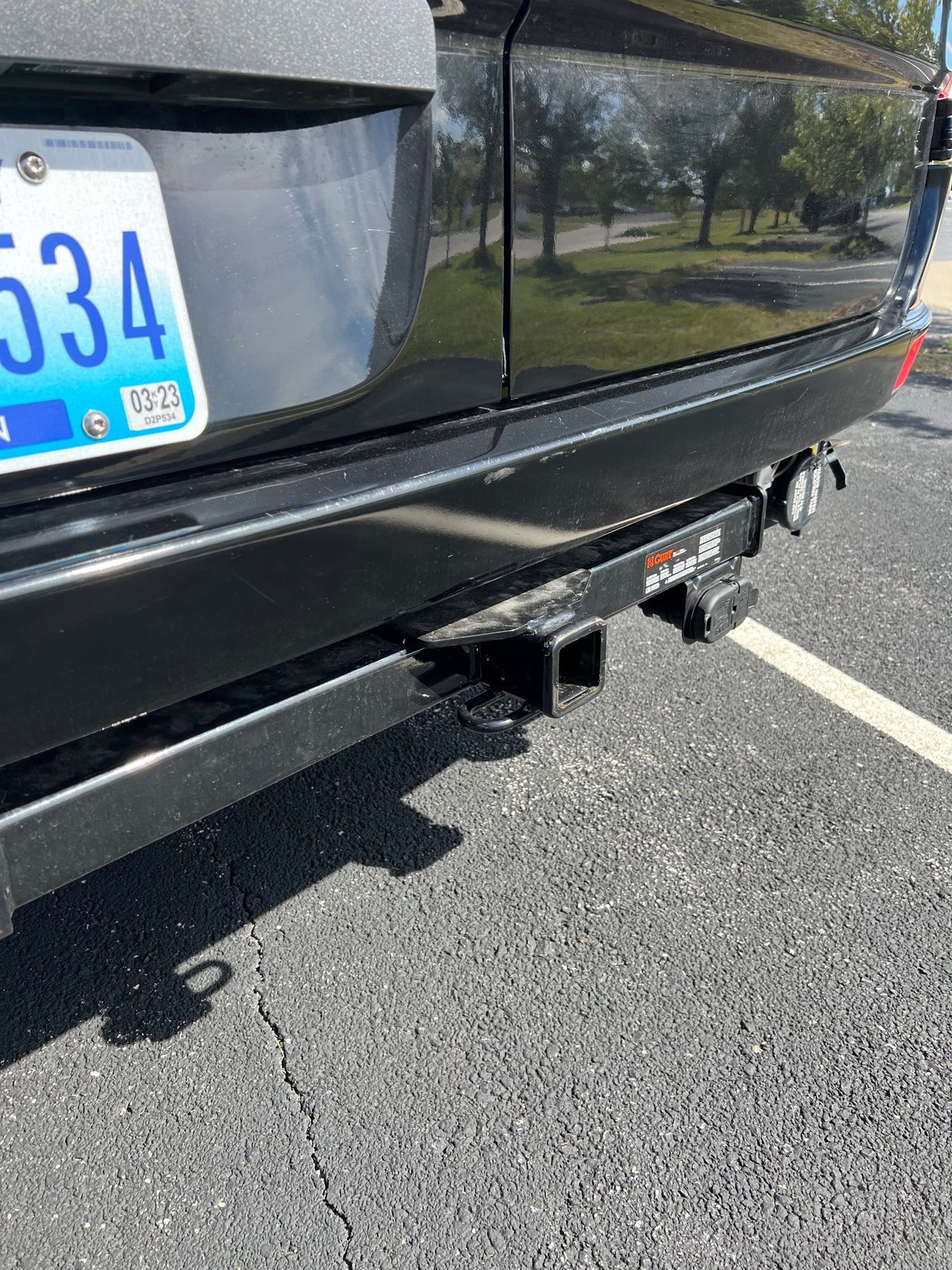 enhancing comfort.|Close-up of an RV rental's fresh and city water connections. A warning label advises sanitizing the tank for safety.|RV rental waste water holding tank cap