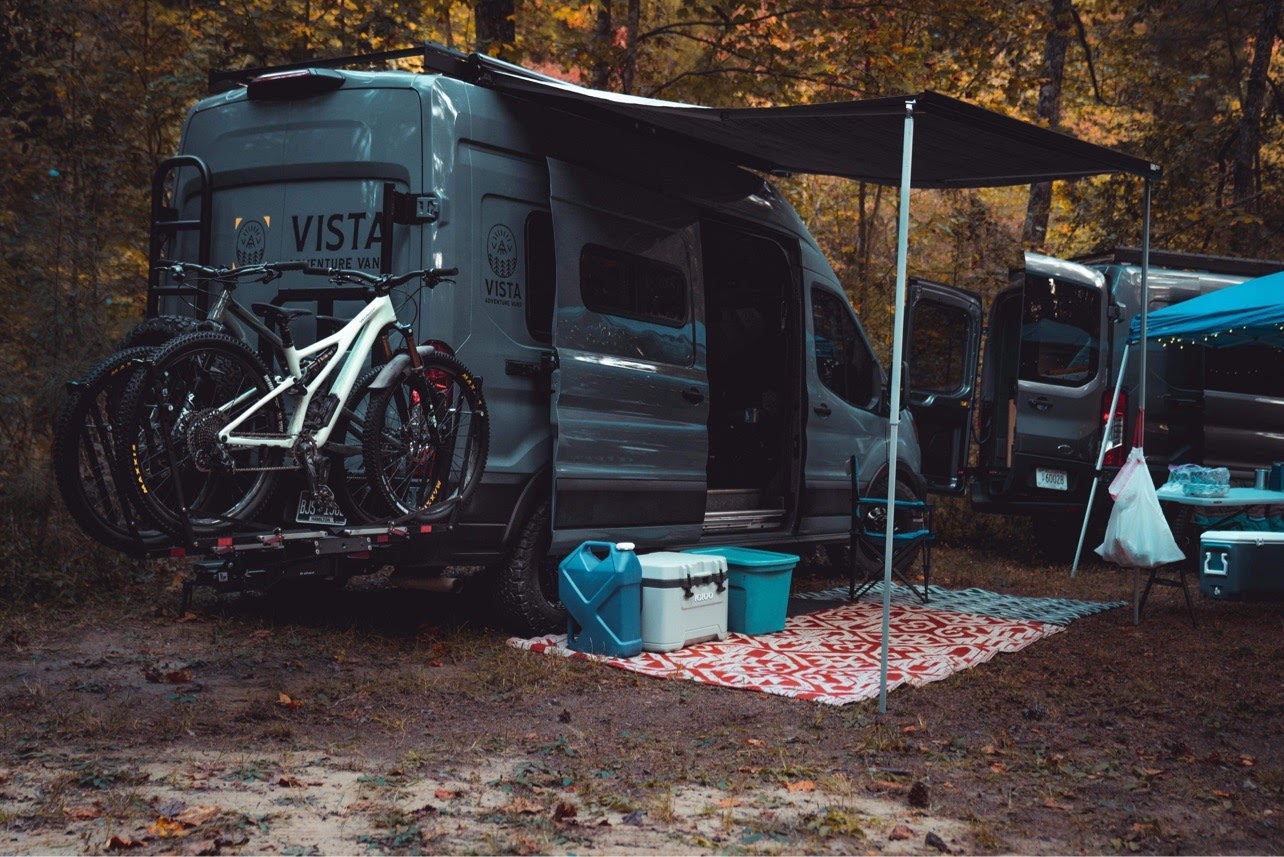 & scenic lake view.|RV rental interior features a compact kitchen with integrated stove