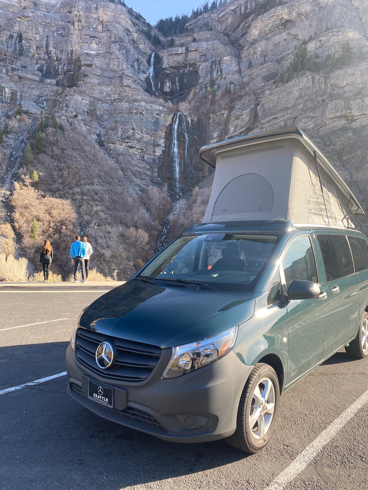 A green pop-top Mercedes-Benz camper van (RV rental) parked