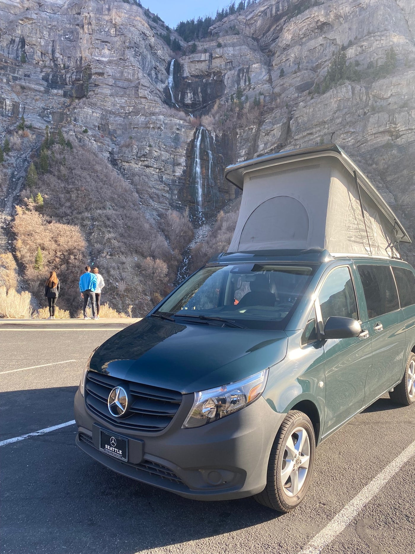 A green pop-top Mercedes-Benz camper van (RV rental) parked — photo 1