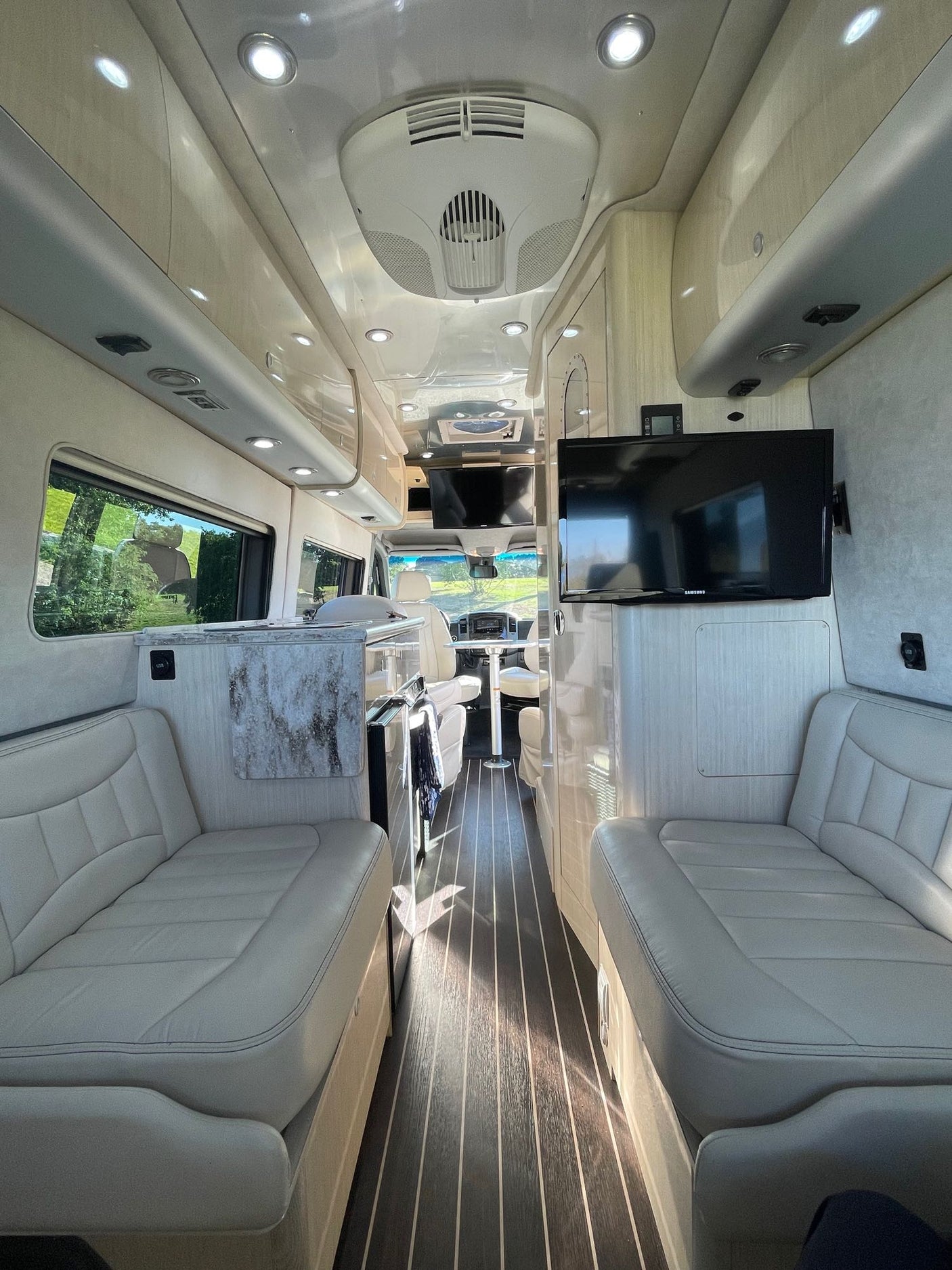 and cozy seating. Perfect for road trips and adventure.|Bright RV rental interior with compact kitchen