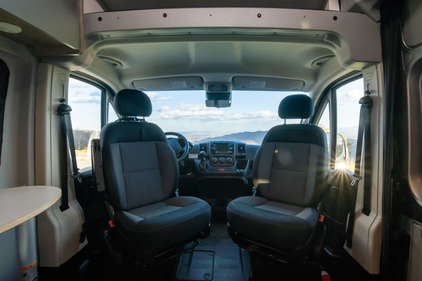 and stunning mountain views from its window.|Step inside this modern RV rental: a compact interior features a kitchenette