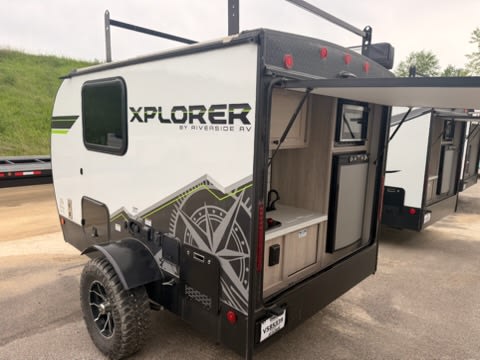 perfect for off-road camping.|This compact RV rental features a well-equipped outdoor kitchen with a microwave — photo 4