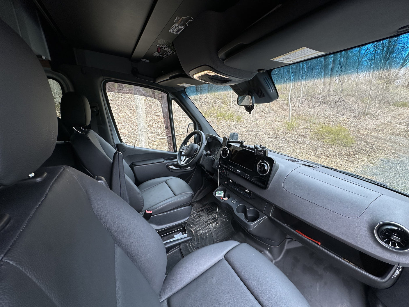 Inside a spacious van, perfect for your next RV rental adventure. Features a modern dashboard & comfortable front seats.