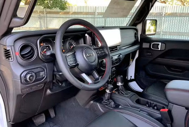 featuring a rooftop tent. Great rv rental for off-road adventures.|Inside a Jeep's driver cabin