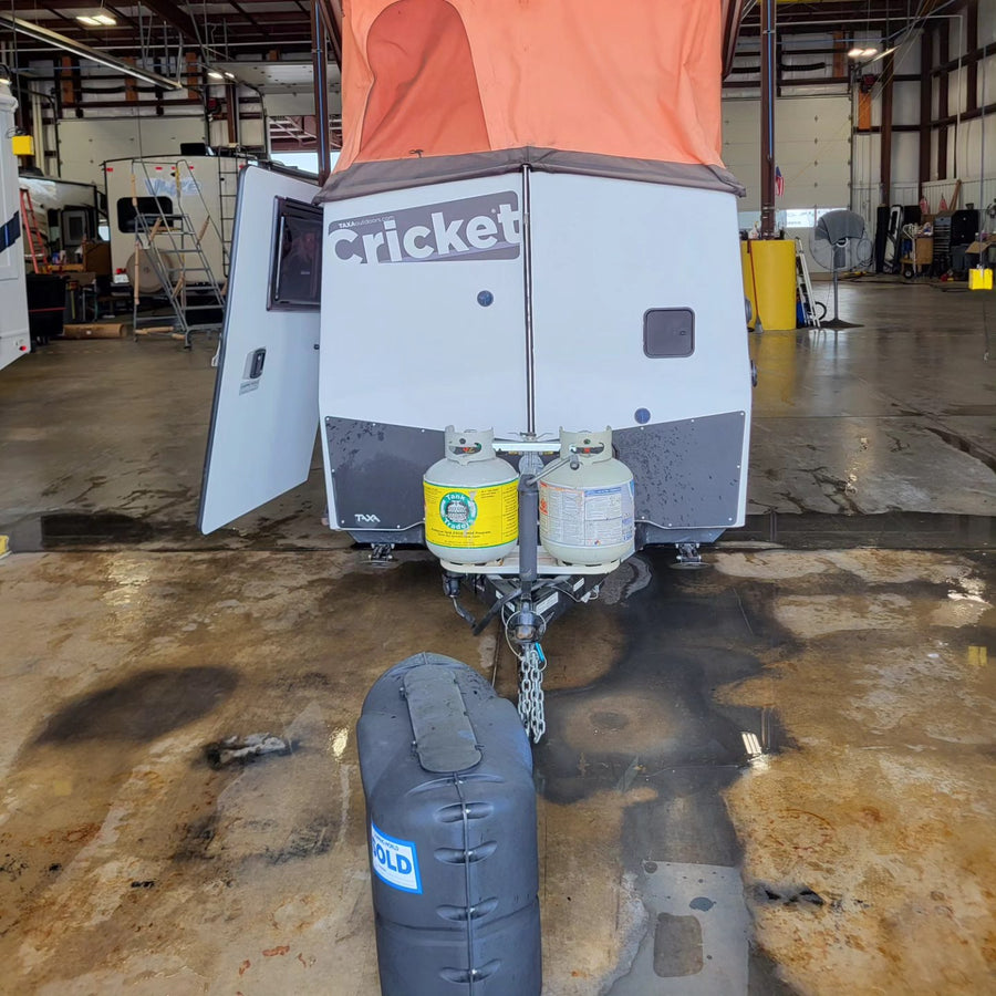 parked in Las Vegas with the Luxor and Excalibur hotels in the background.|Family enjoying a scenic beachfront rv rental campsite with ocean views.|Rear of a Taxa Cricket RV travel trailer