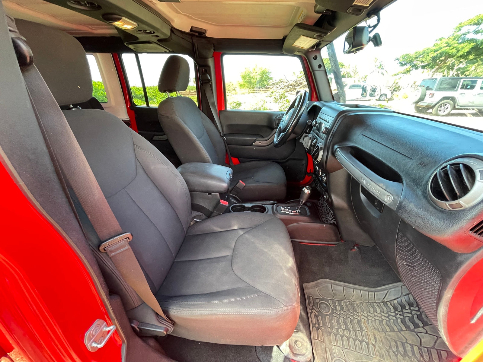 Spacious interior of a red Jeep, ready for your next road trip adventure. Explore our vehicle and RV rental options!