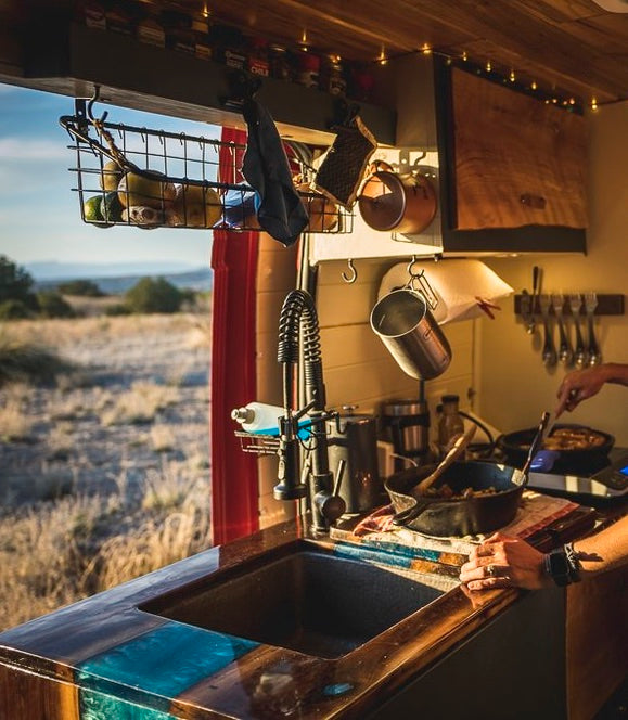 Cozy RV rental kitchen with a scenic view, perfect for cooking delicious meals while exploring the outdoors.