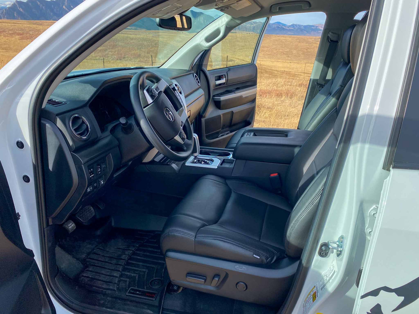 ready for your rv rental adventure.|Spacious white truck interior with black leather seats