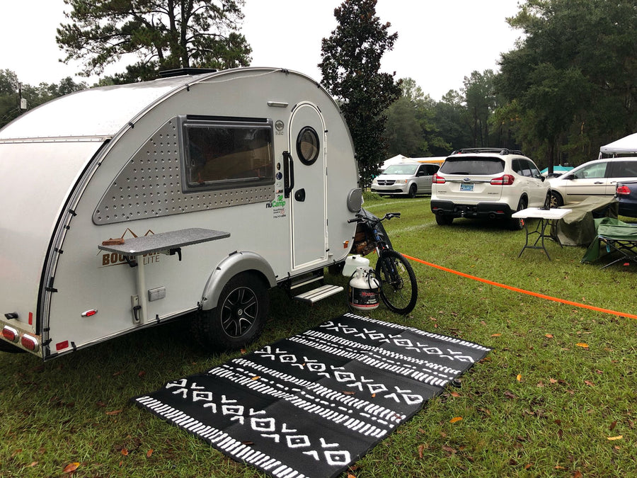 a nuCamp setup on grass with mat