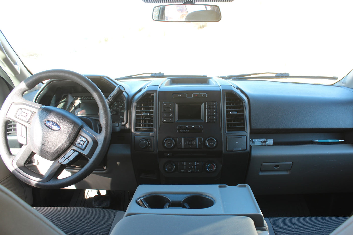 Dashboard and steering wheel of a Ford vehicle, ideal for an rv rental, showing interior controls & center console. — photo 5