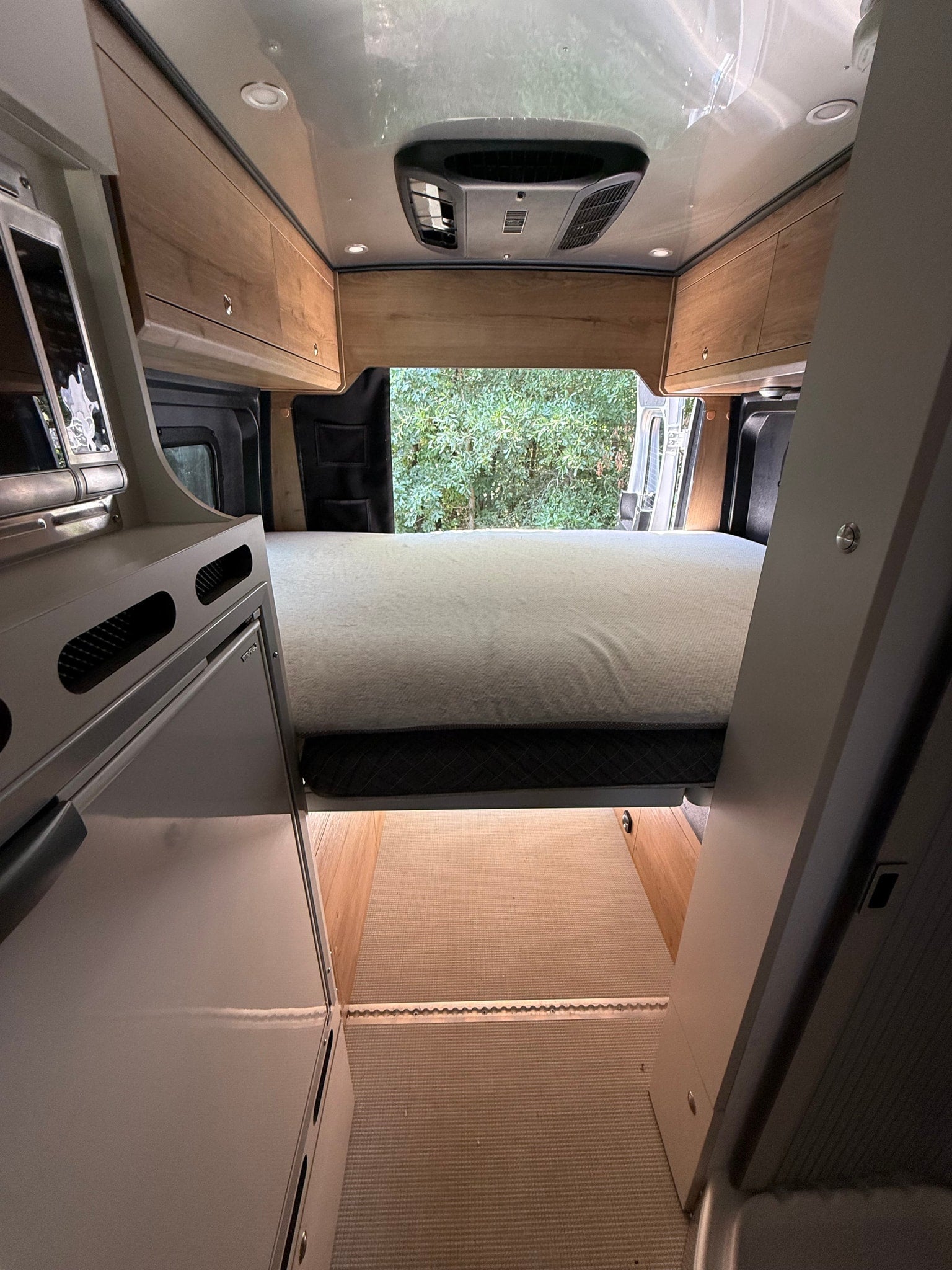parked on asphalt. Features side steps & roof AC
