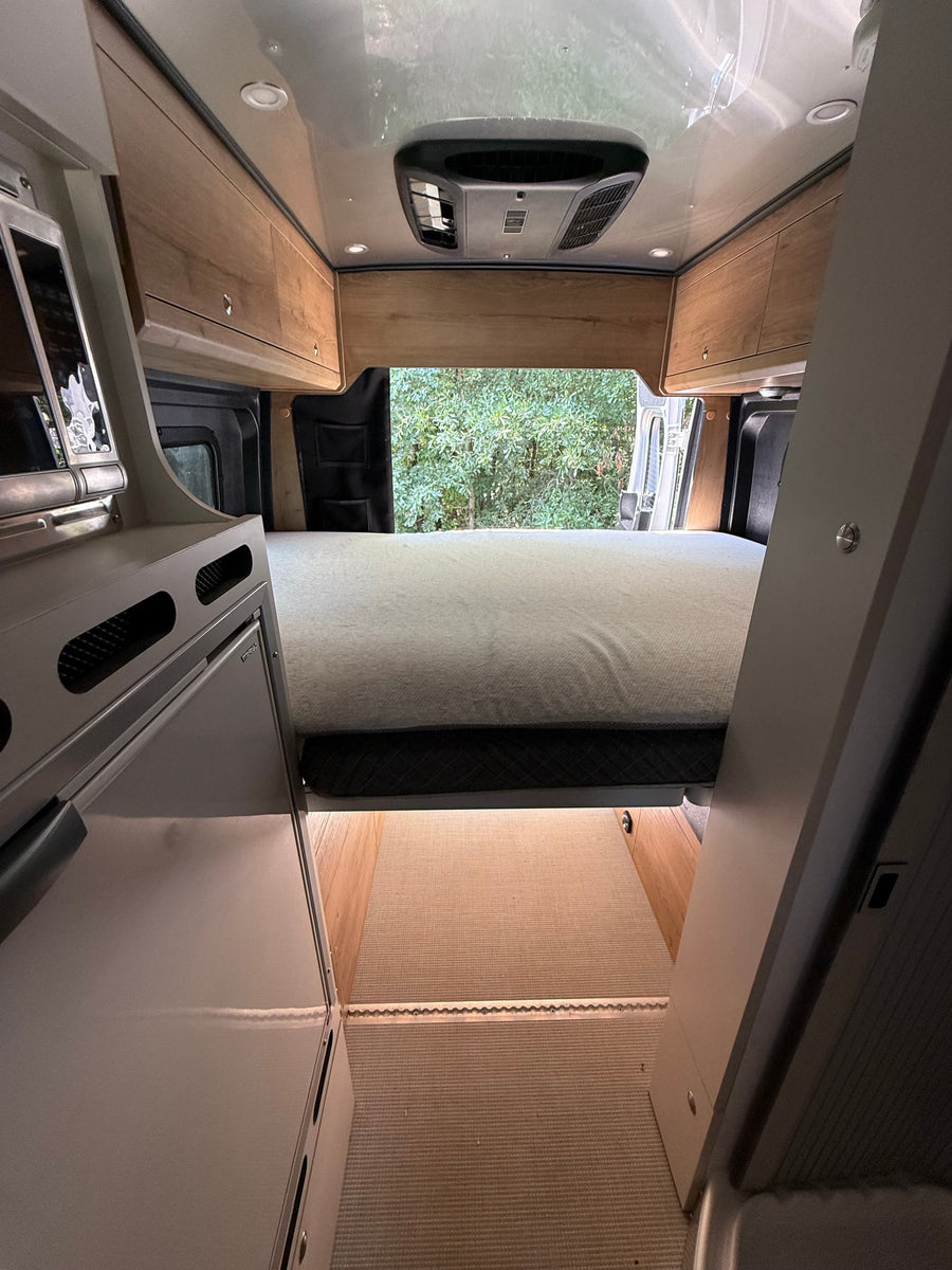 parked on asphalt. Features side steps & roof AC