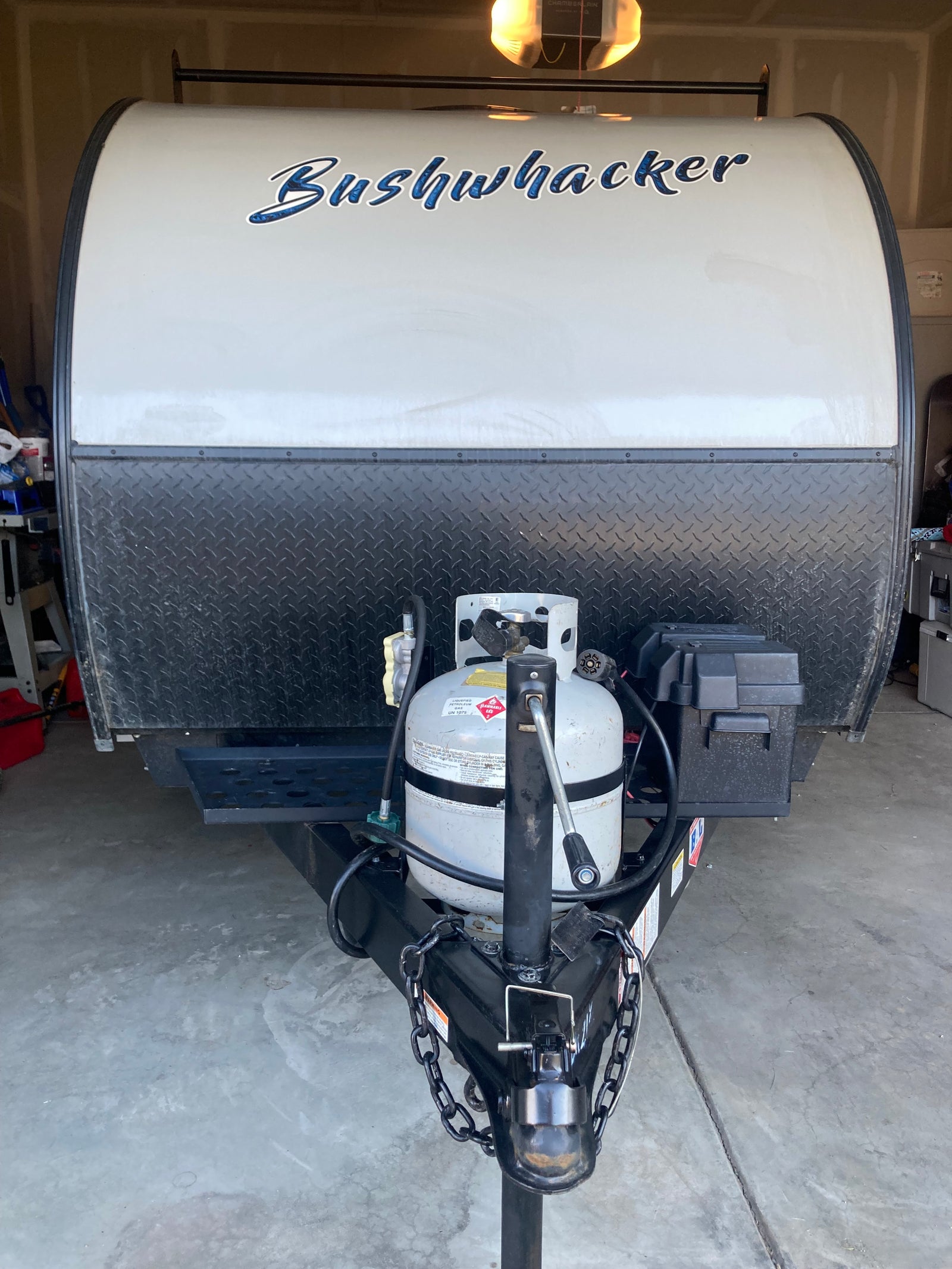 Front of a Bushwhacker travel trailer, ideal for an **rv rental** adventure. Features propane tank & hitch.