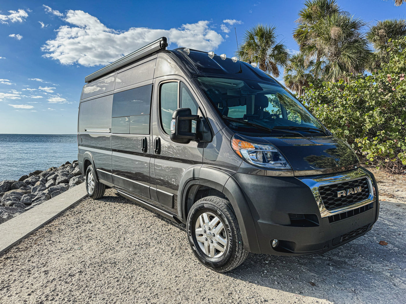 and comfortable living area.|Step inside this modern RV rental camper van. Enjoy a full bed — photo 12