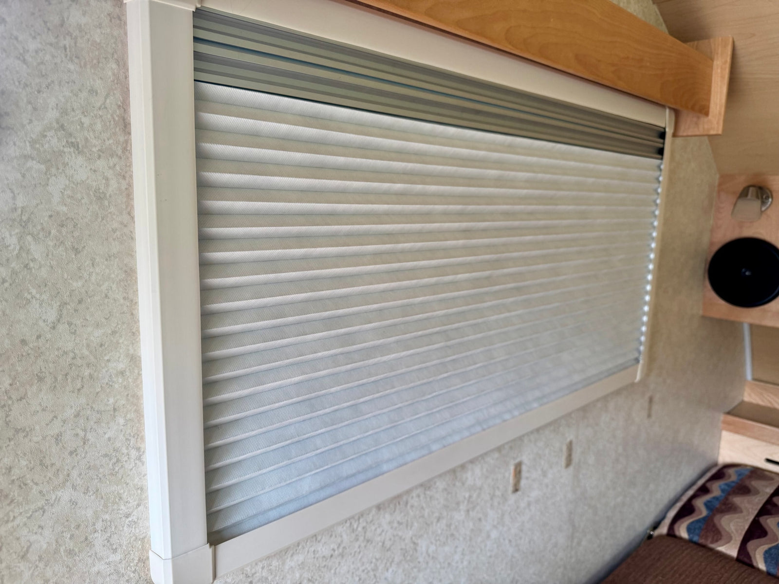 and windows.|Compact rv rental interior with light wood cabinetry