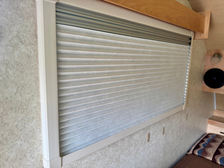 and windows.|Compact rv rental interior with light wood cabinetry