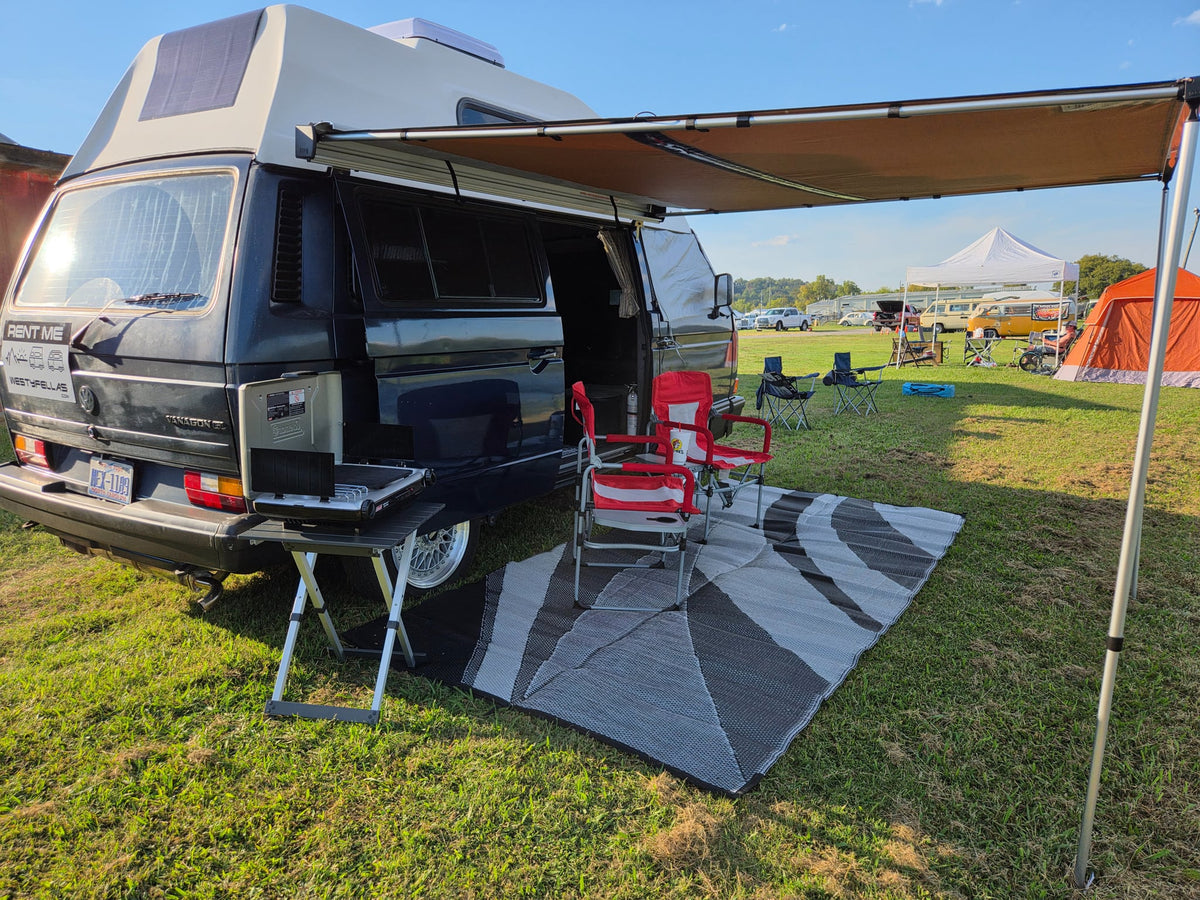 and dashboard. Ready for adventure!|Cozy Westfalia camper van interior with kitchenette & seating. Ideal for your next rv rental road trip.|Blue VW camper van (potential rv rental) with an 'OUTATIME' plate — photo 6