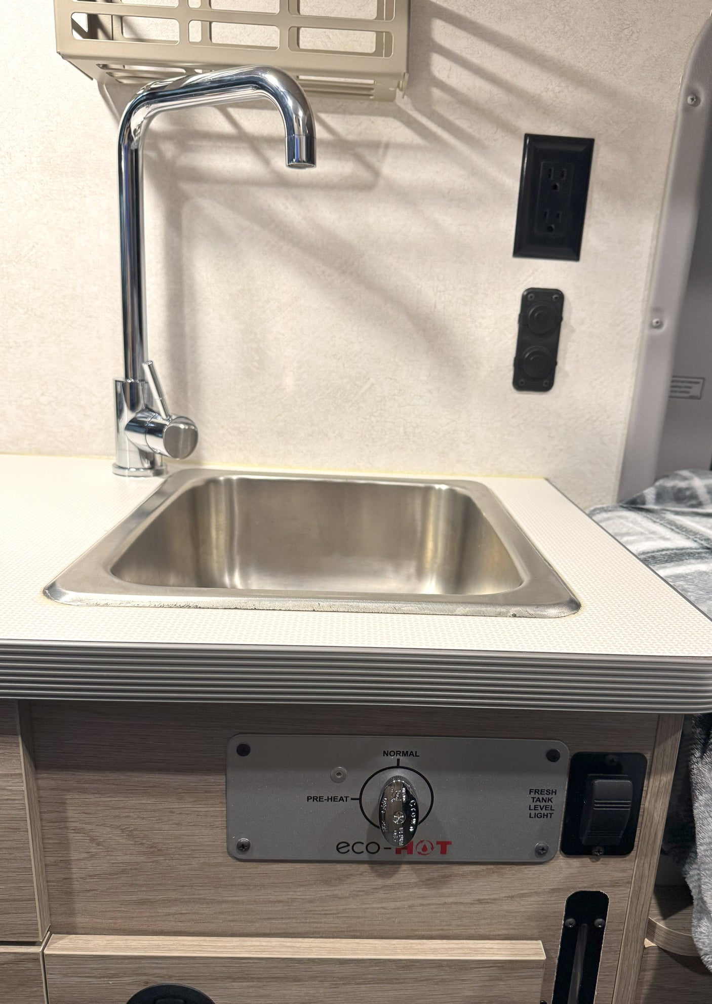 Your RV rental includes a convenient kitchen sink, chrome faucet, wall power, and an eco-HOT water heater control panel.