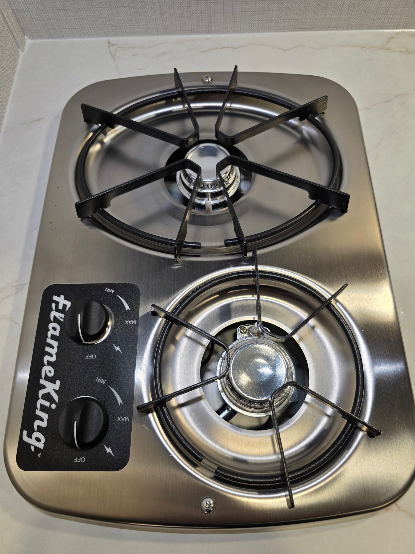 A new, clean Flame King stainless steel two-burner gas cooktop, common in an RV rental.