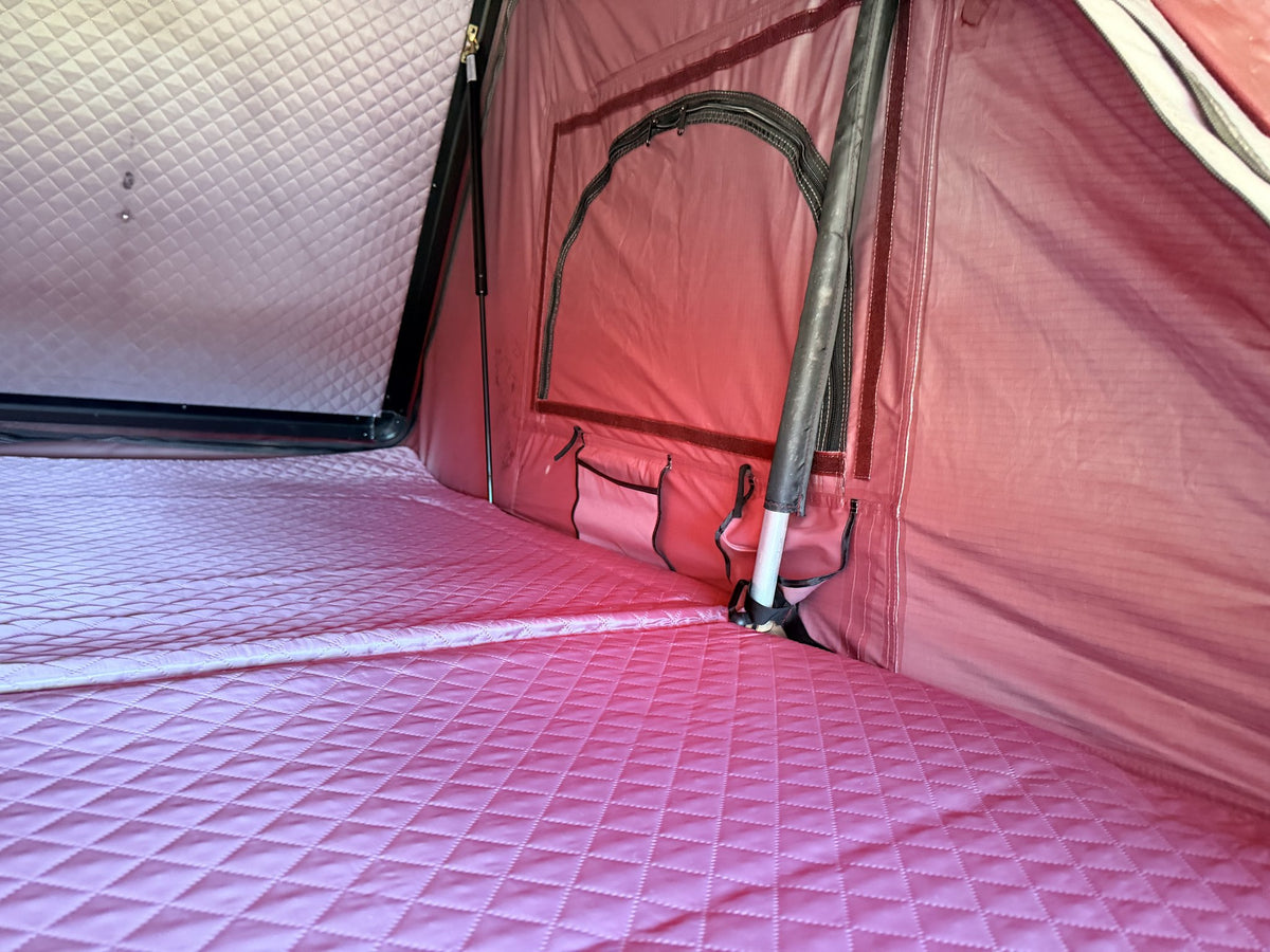 Interior corner showing a screened window, storage pocket and support pole — photo 7