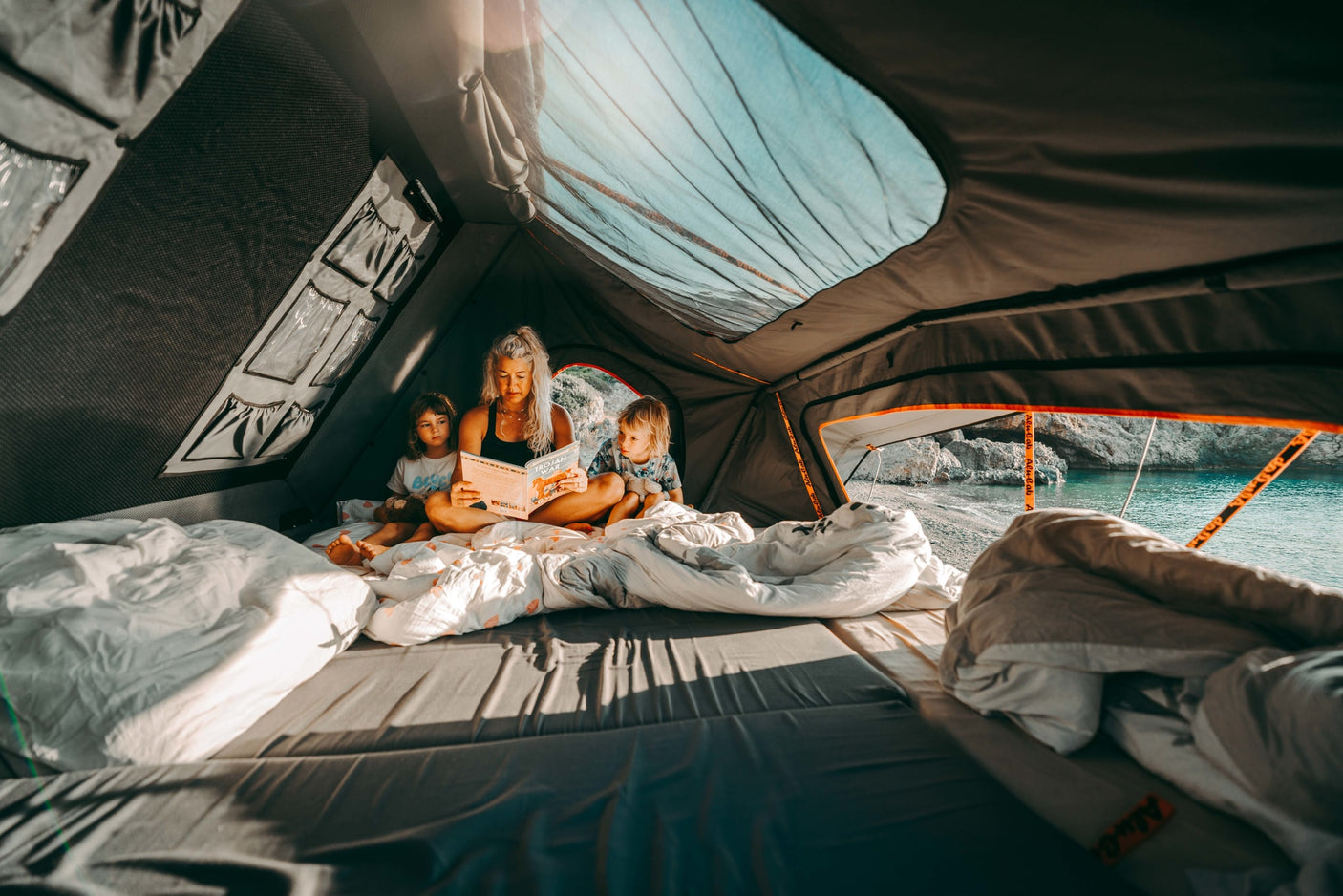 and organized storage for gear.|Outdoor breakfast with your RV rental! A person cooks bacon on a portable griddle