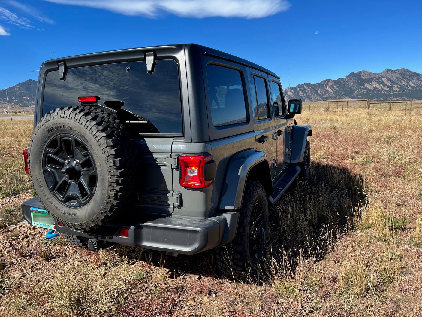 Gray Jeep Wrangler in CO mountains, ready for adventure. A rugged alternative for your next outdoor RV rental escape.