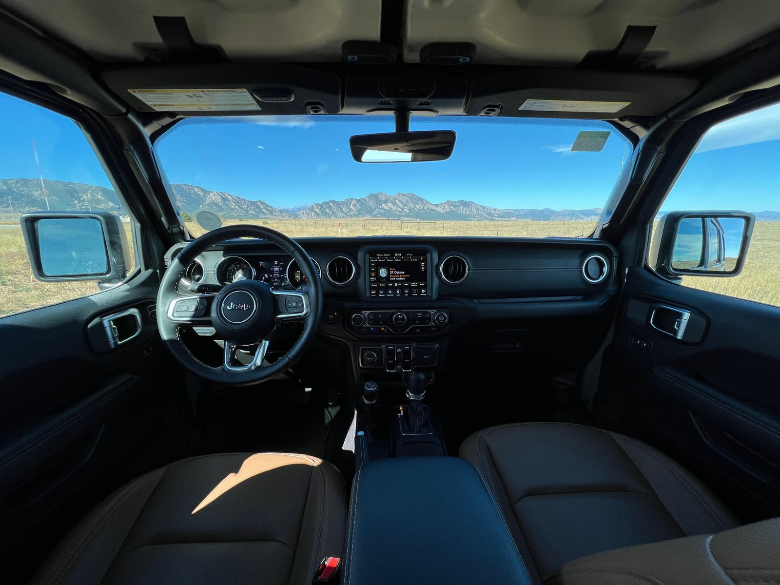 Jeep interior with mountain view, ready for adventure. A rugged alternative to an RV rental for scenic drives.