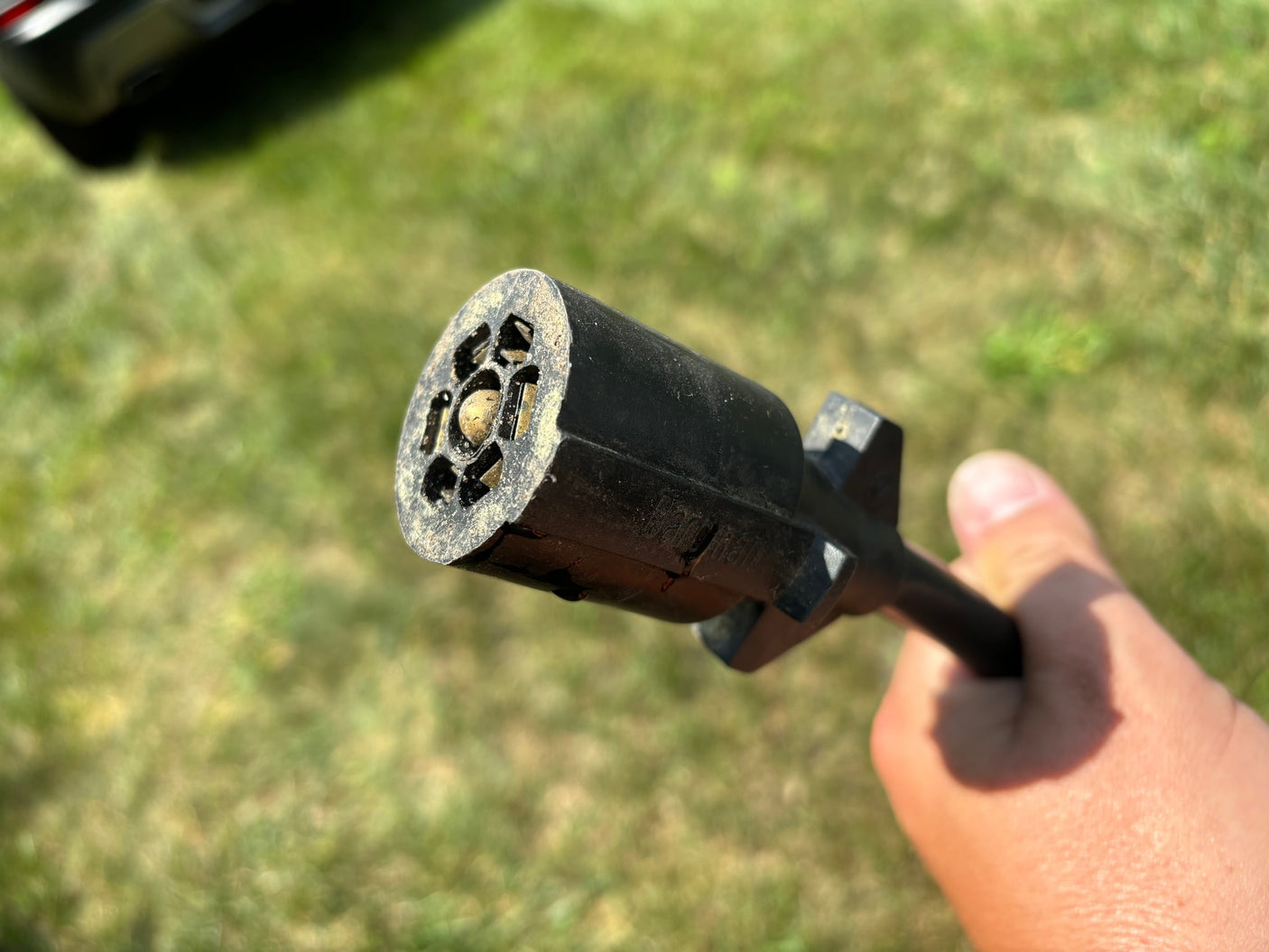 Close-up of a 7-pin RV trailer electrical connector, vital for powering your RV rental.