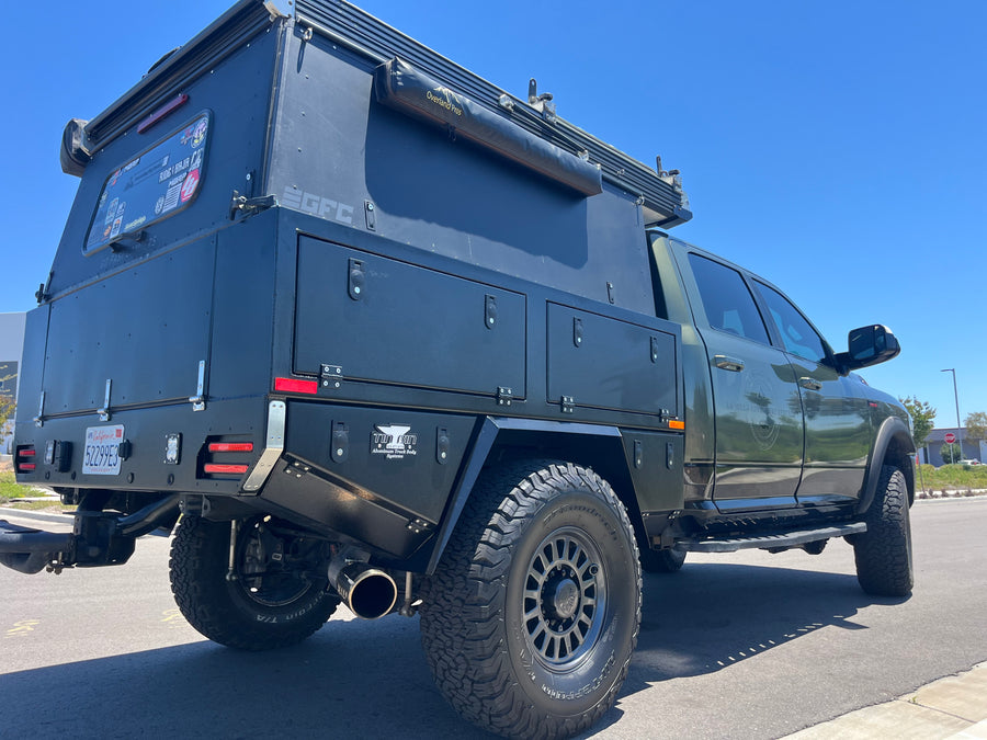 This robust truck camper, part of an RV rental fleet, is equipped for rugged overland trips.