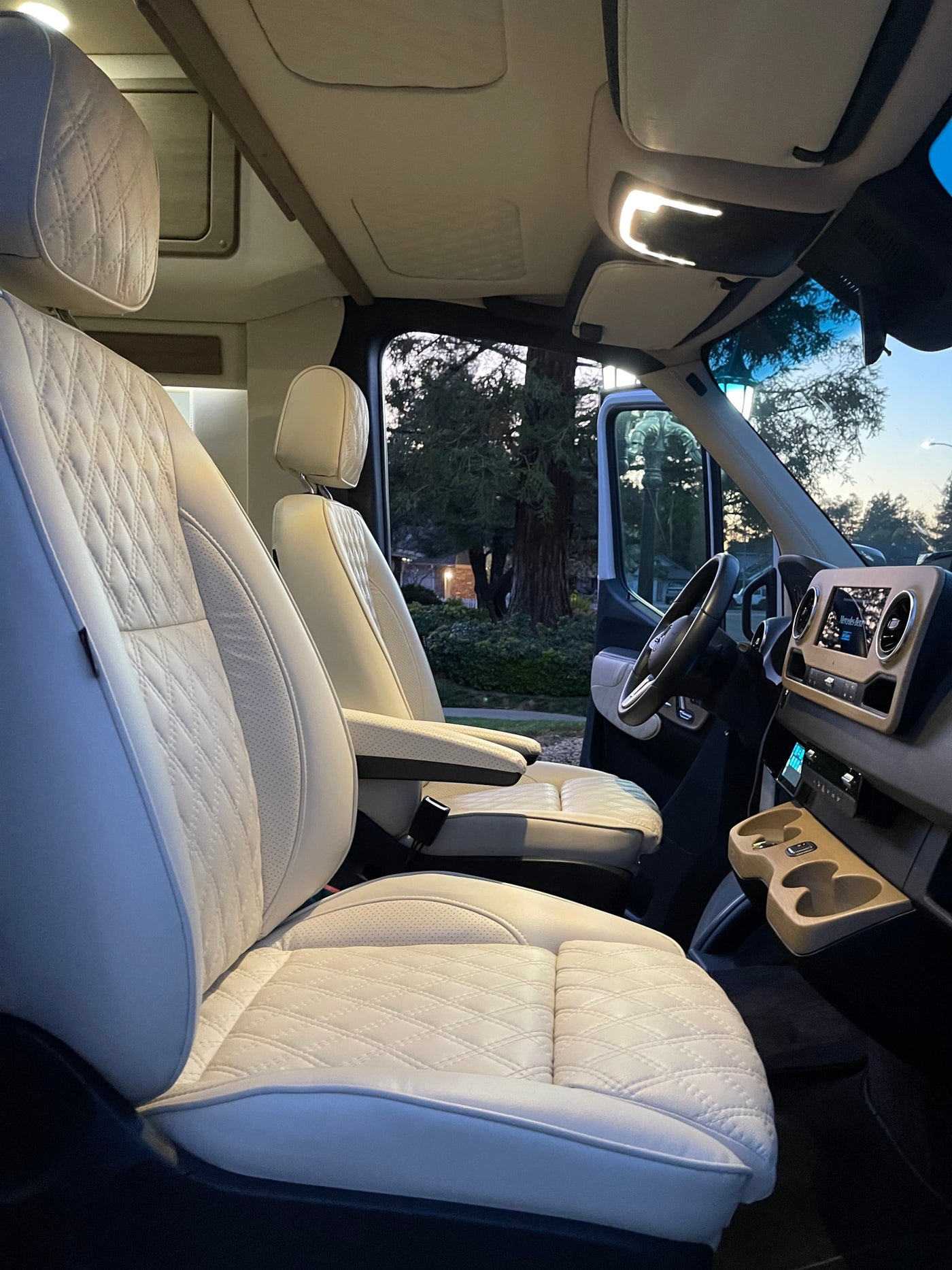 Step inside this luxurious RV rental. Enjoy plush quilted leather seats and a sophisticated dashboard, perfect for your journey. — photo 9