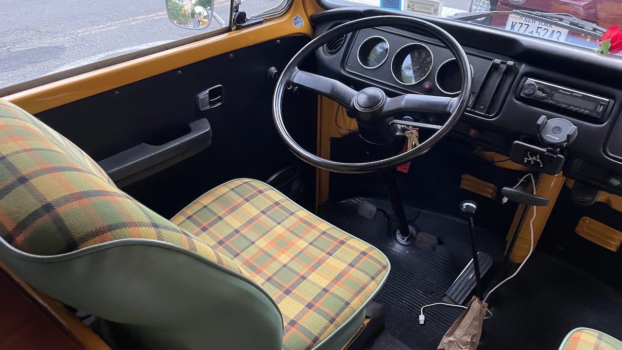 parked in a sunny campground.|Dynamic street art mural and a vintage yellow VW Westfalia