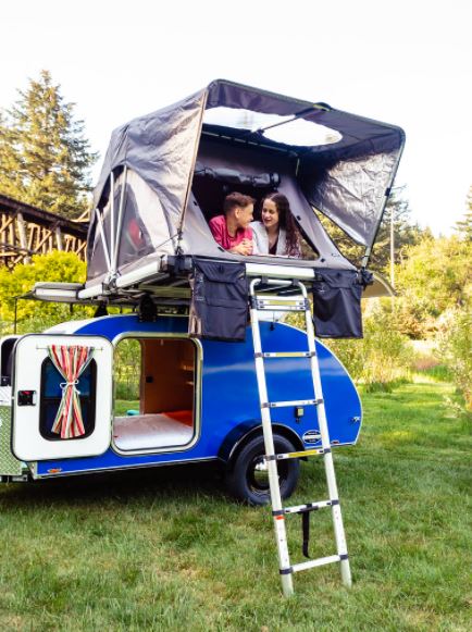 ready for camping adventures.|Cozy teardrop RV rental interior with a comfy bed
