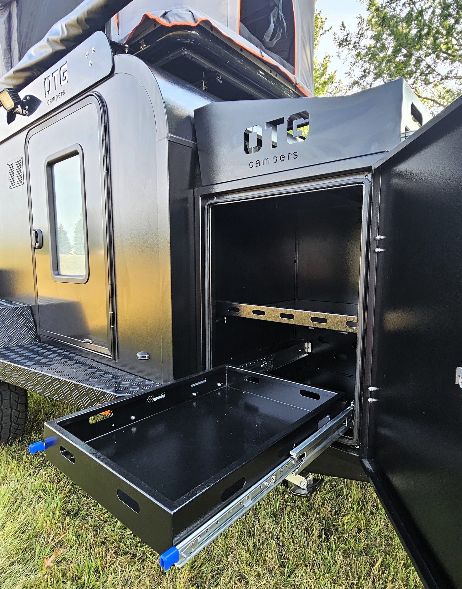a convenient feature for your rv rental.|Black off-road camper trailer with awning & rooftop tent