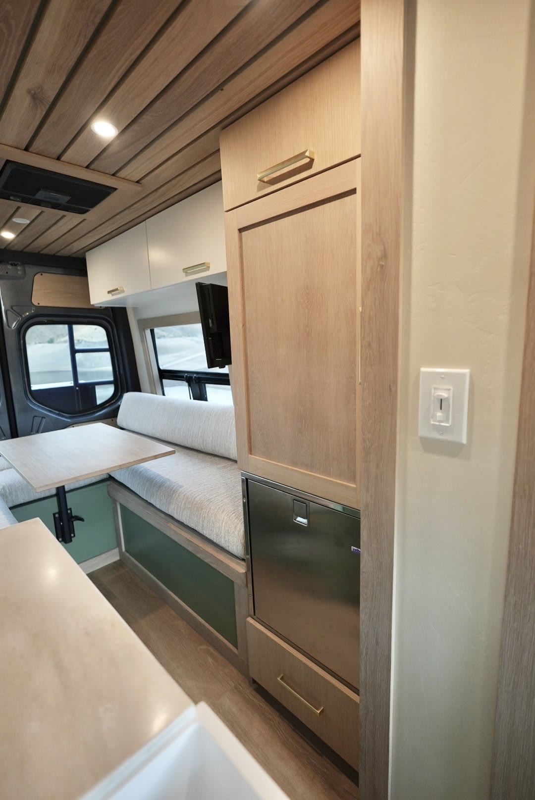 and a desert view from the window.|Rear doors of a gray camper van are open