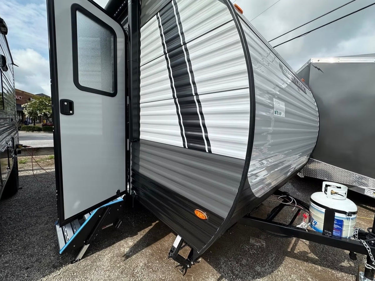 featuring an open door with steps and a rear spare tire.|Grey travel trailer with striped sides and open door with steps — photo 2
