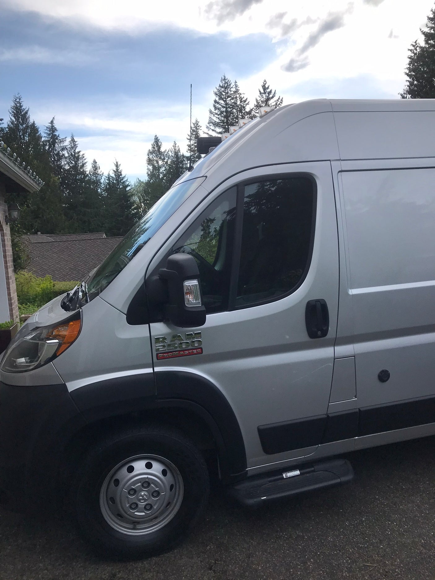 Side view of a high-roof silver Ram ProMaster 2500 van, a spacious option for rv rental.