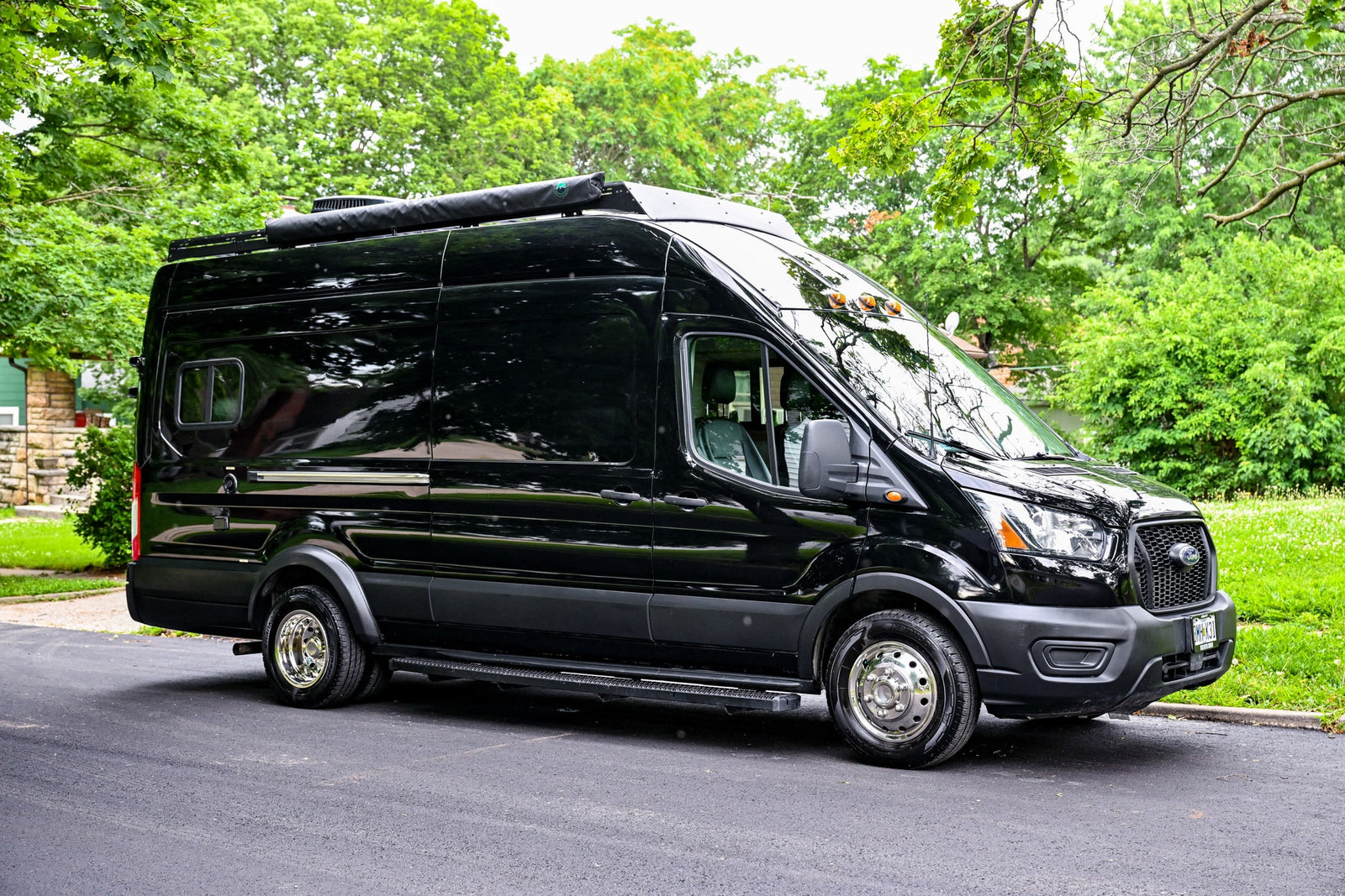 Spacious black Ford Transit RV rental
