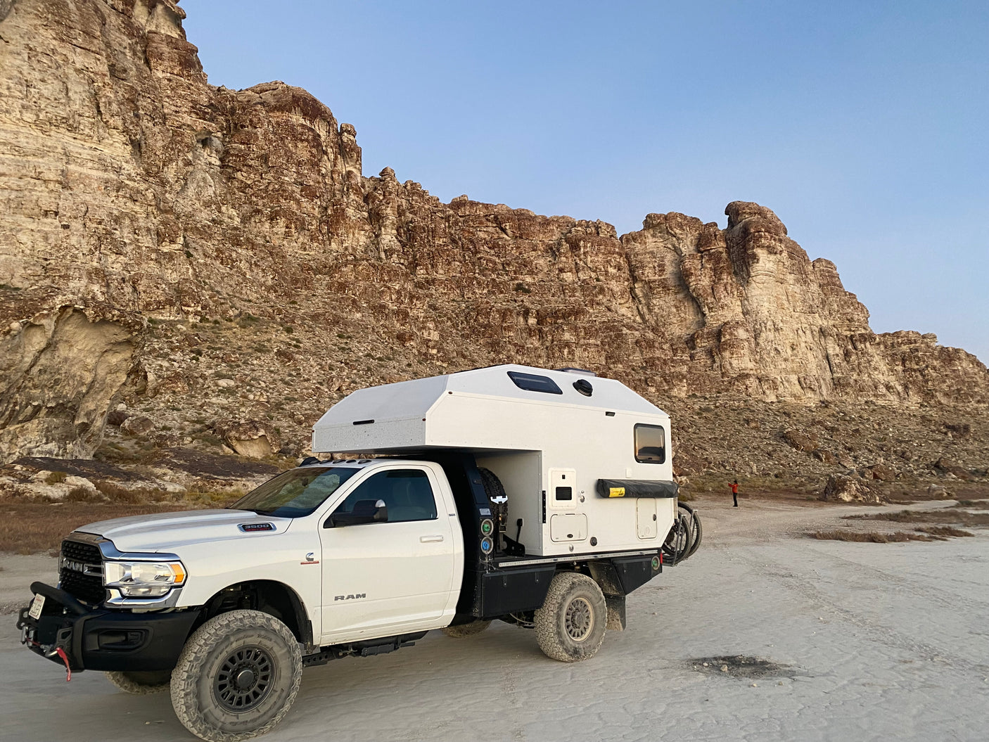 An adventure-ready Ram truck camper, perfect for RV rental off-road trips. Explore rugged landscapes with this expedition vehicle.