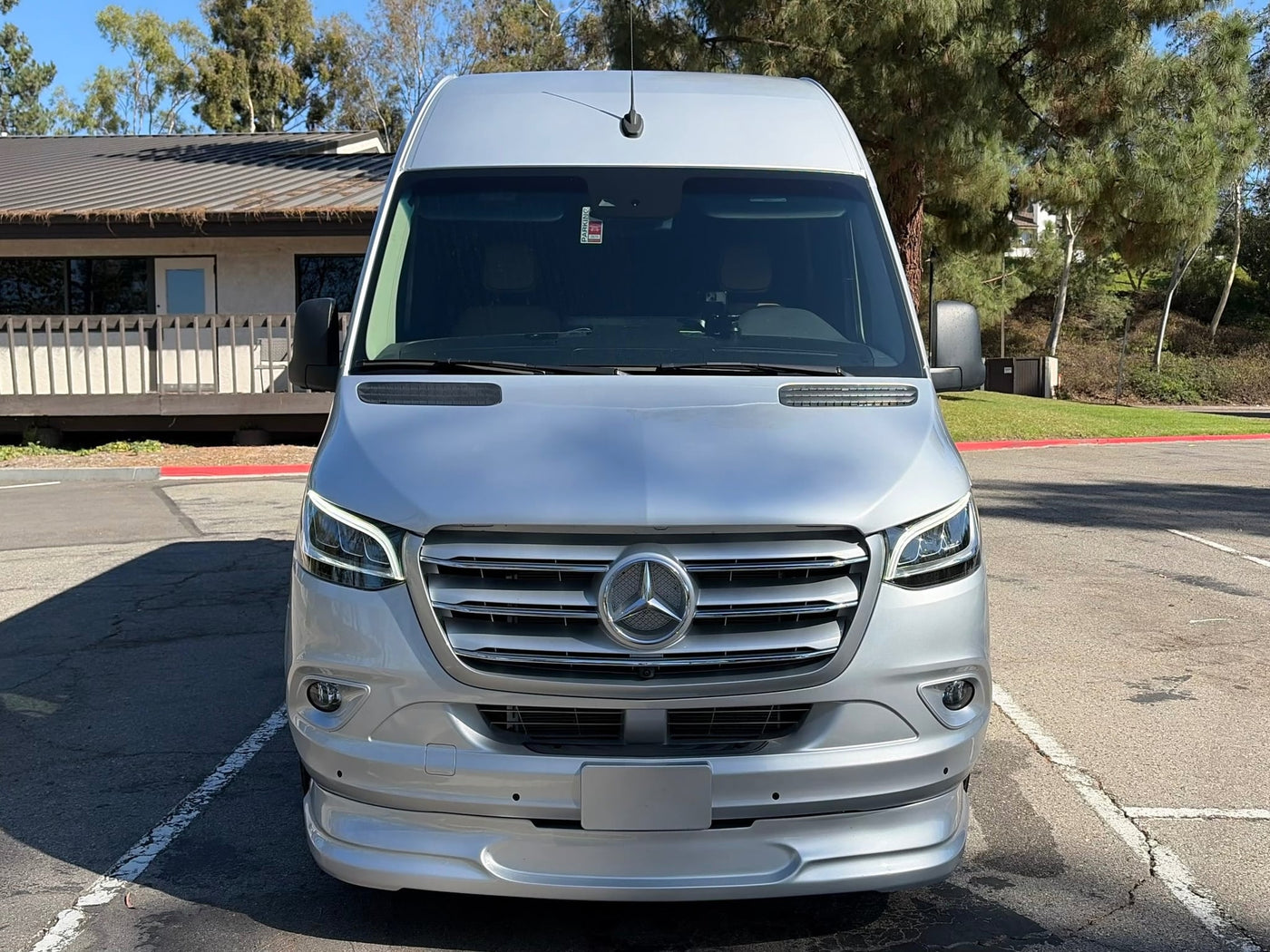 an ideal rv rental. It features dark tinted windows and a California license plate.|Front view of a silver Mercedes Sprinter van — photo 4