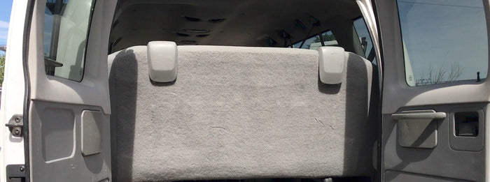 RV rental rear interior: open doors reveal a grey bench seat, providing ample space for passengers or cargo for your trip.