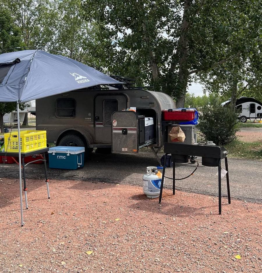 An RV rental campsite with a compact trailer