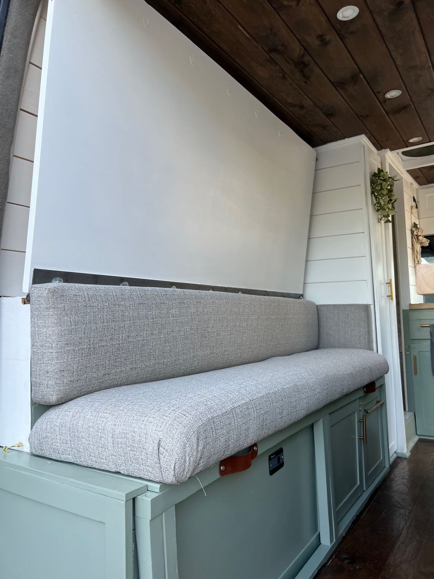 Spacious RV rental interior with convertible bench seating, ample storage, and warm wooden ceiling.