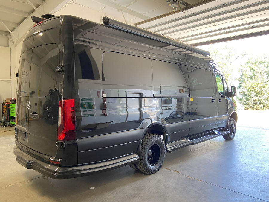 and smart controls.|A sleek black Mercedes-Benz Sprinter luxury van with all-terrain tires